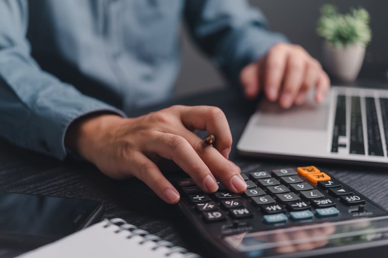 Businessman using calculator for financial planning and budgeting
